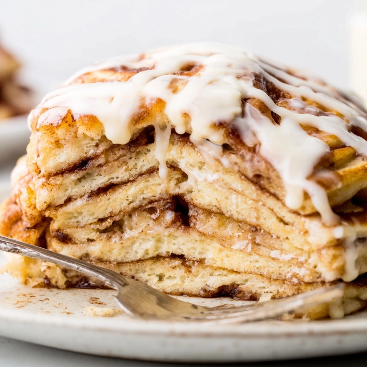 Warm Cinnamon Roll Pancake Bake, showing a close up of the gooey, cinnamon swirl.