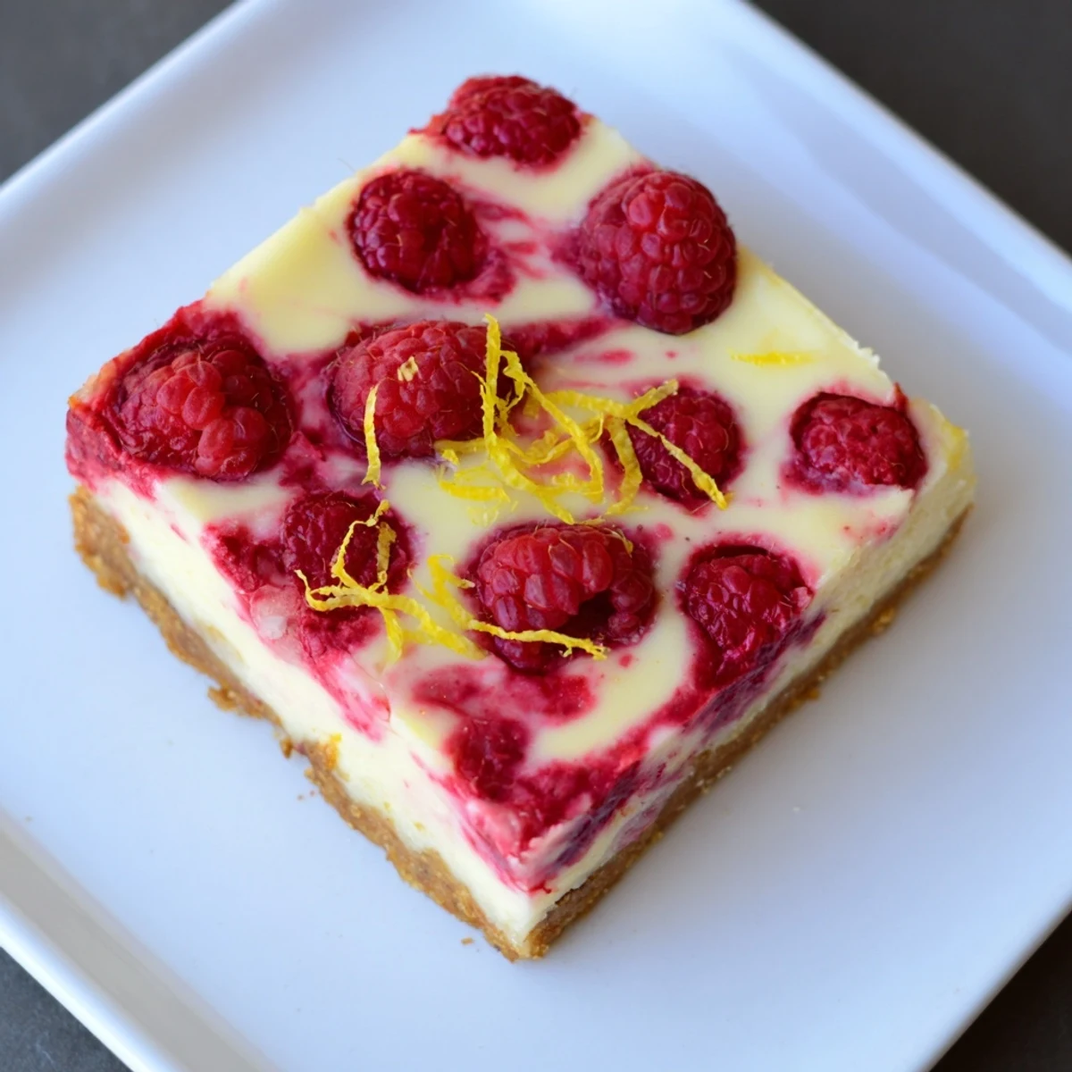 Fresh, chilled Lemon Raspberry Cheesecake Bars: a sweet, tangy treat perfect for summer gatherings.