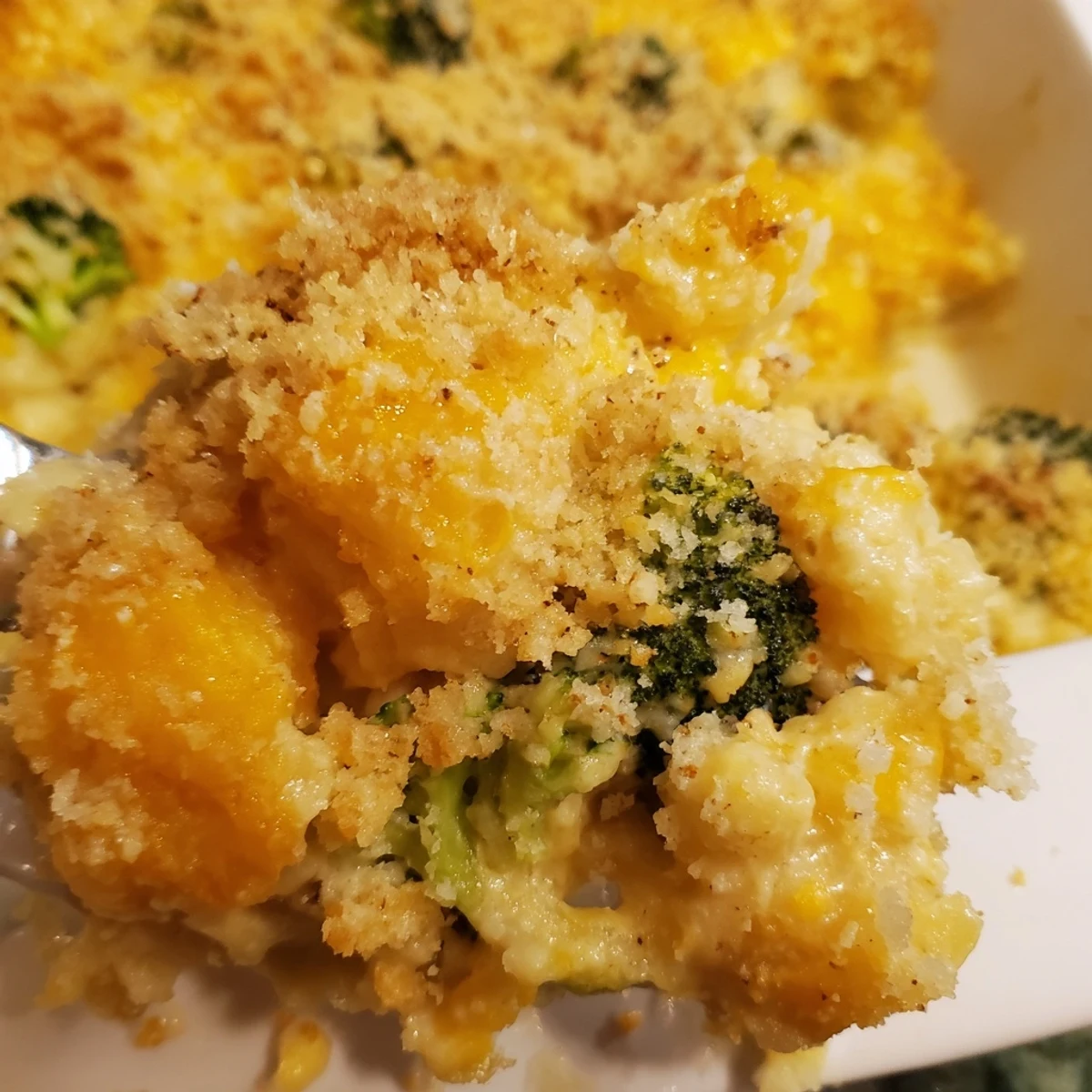 This photo depicts a warm, bubbling Cheesy Potato and Broccoli Casserole straight from the oven, ready to serve.