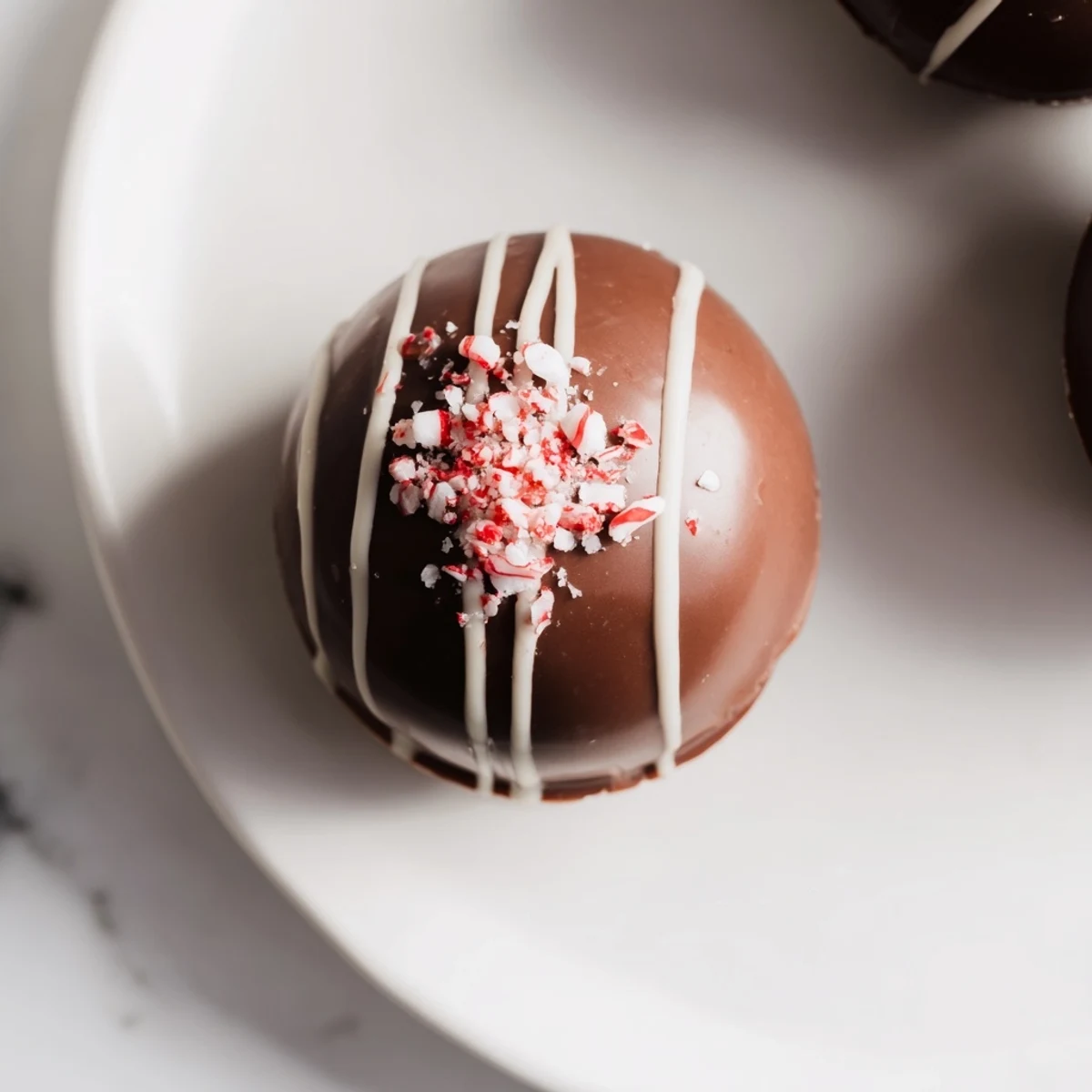 See delightful Peppermint Hot Cocoa Bombs: chocolate spheres filled with marshmallows and cocoa, ready to burst with flavor.