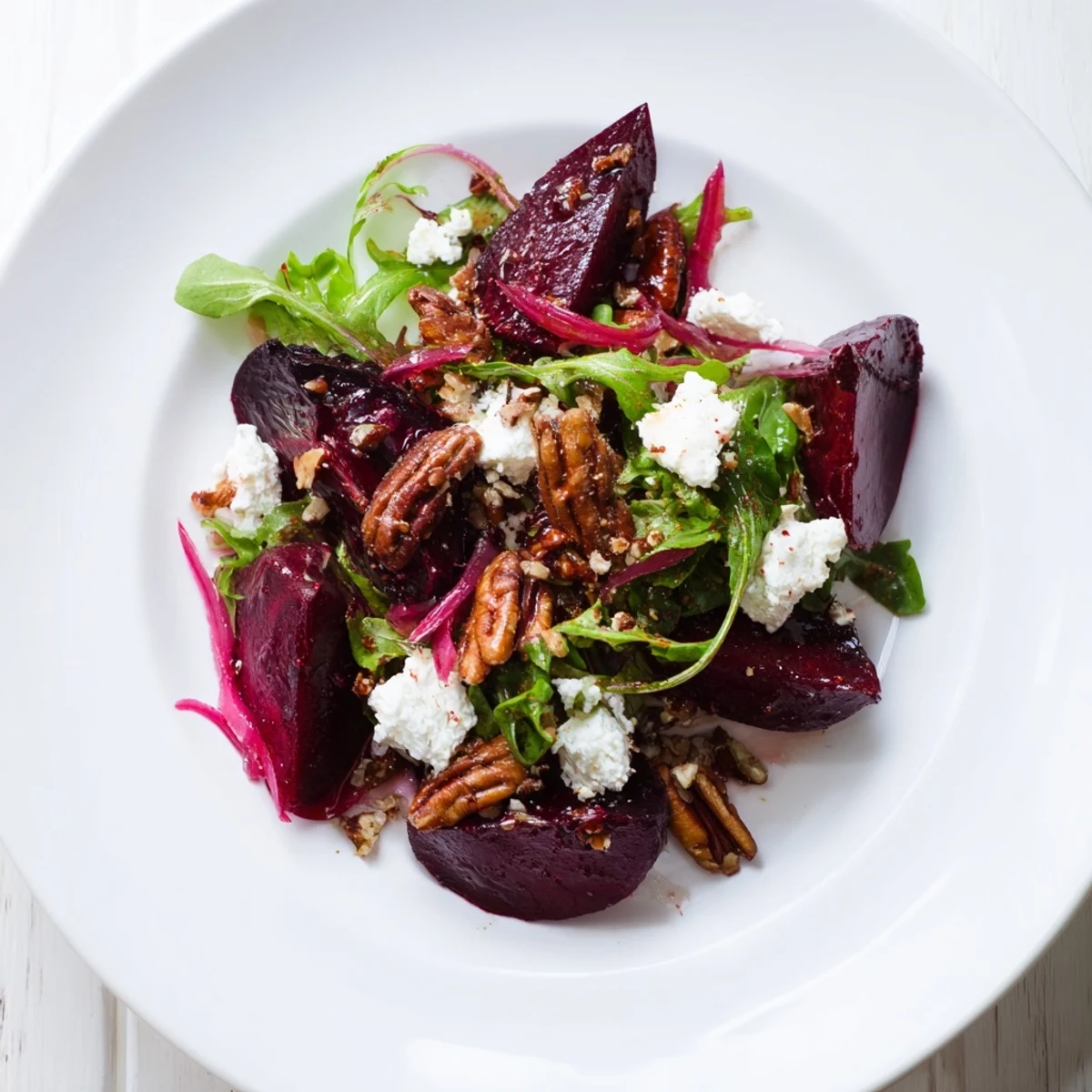This delicious Roasted Beet and Feta Salad features colorful beets, feta crumbles, and hints of toasted nuts.