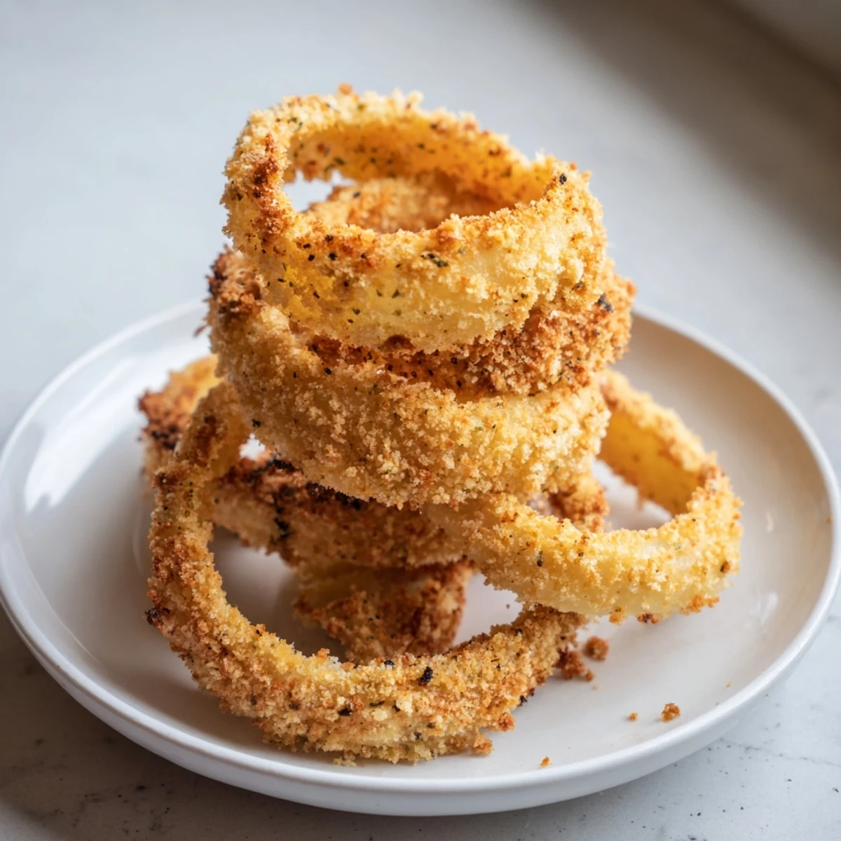 Close-up of freshly fried onion rings, showcasing their light batter and flavorful texture.