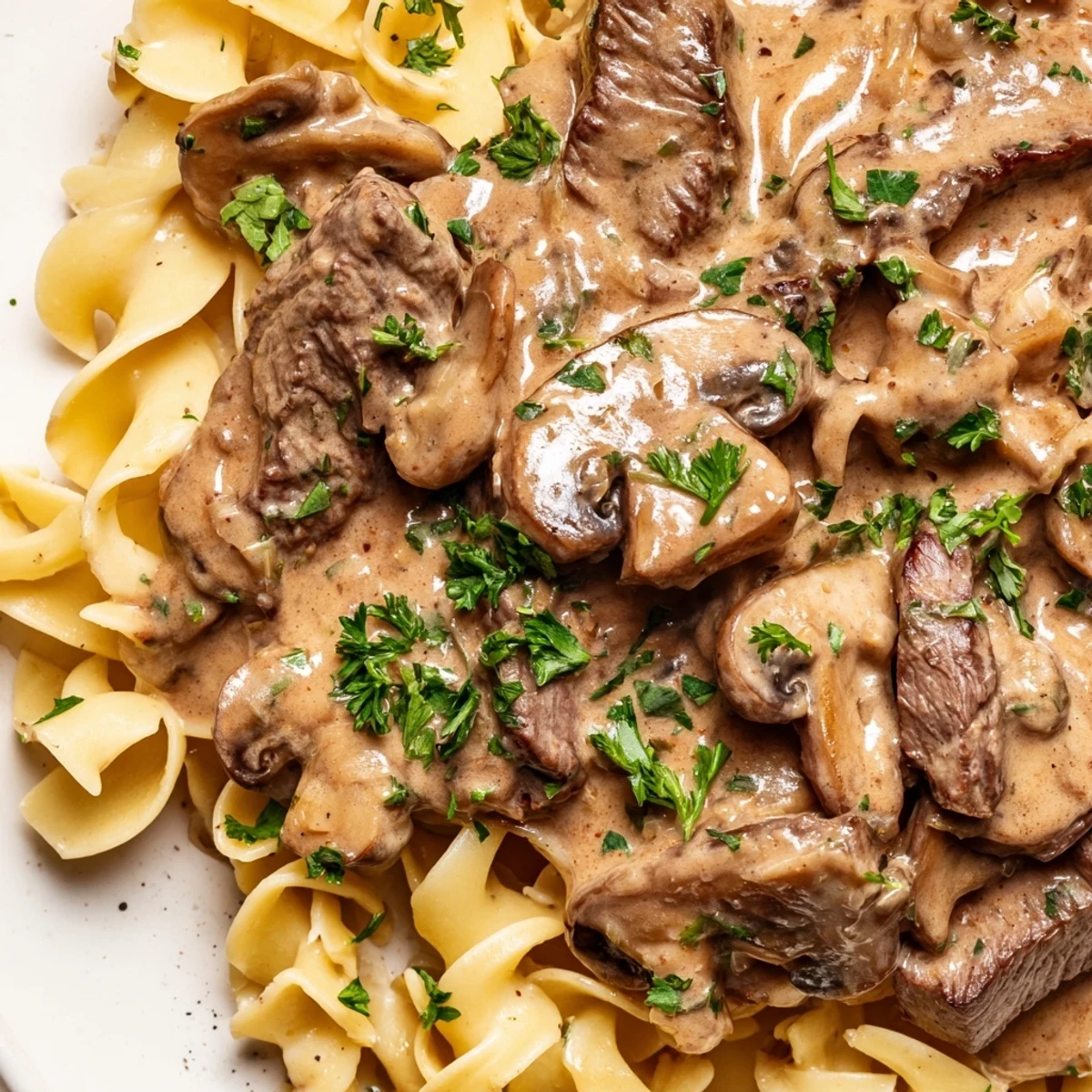 Tender beef strips and cremini mushrooms coated in creamy gravy over egg noodles.