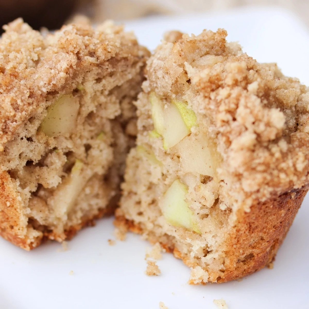Golden-brown Cinnamon Apple Muffins with Streusel cooling on a wire rack, steam rising from tender apple interiors.