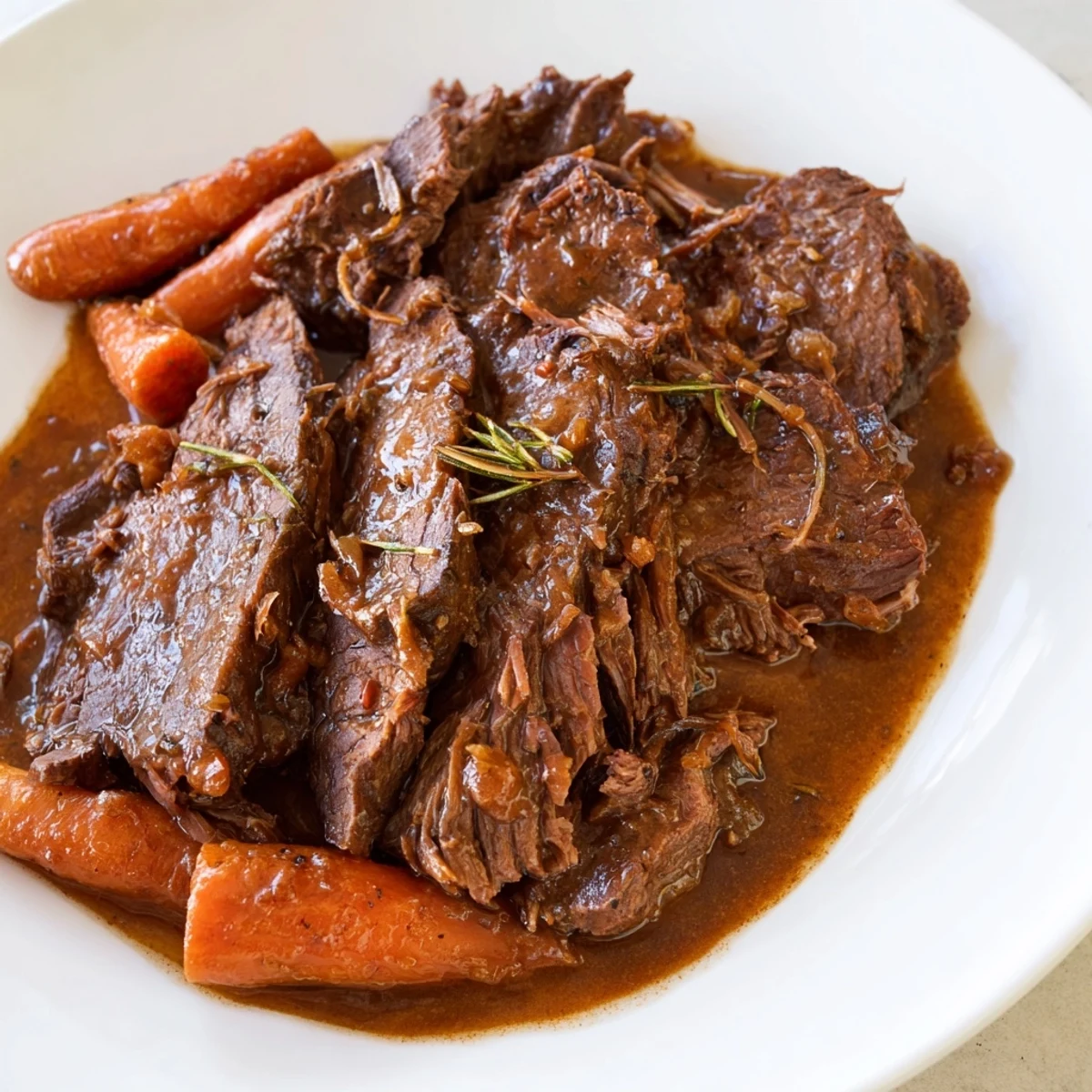 Tender beef and sweet carrots in Slow Cooker Pot Roast with Carrots, served in a rustic bowl with savory juices.