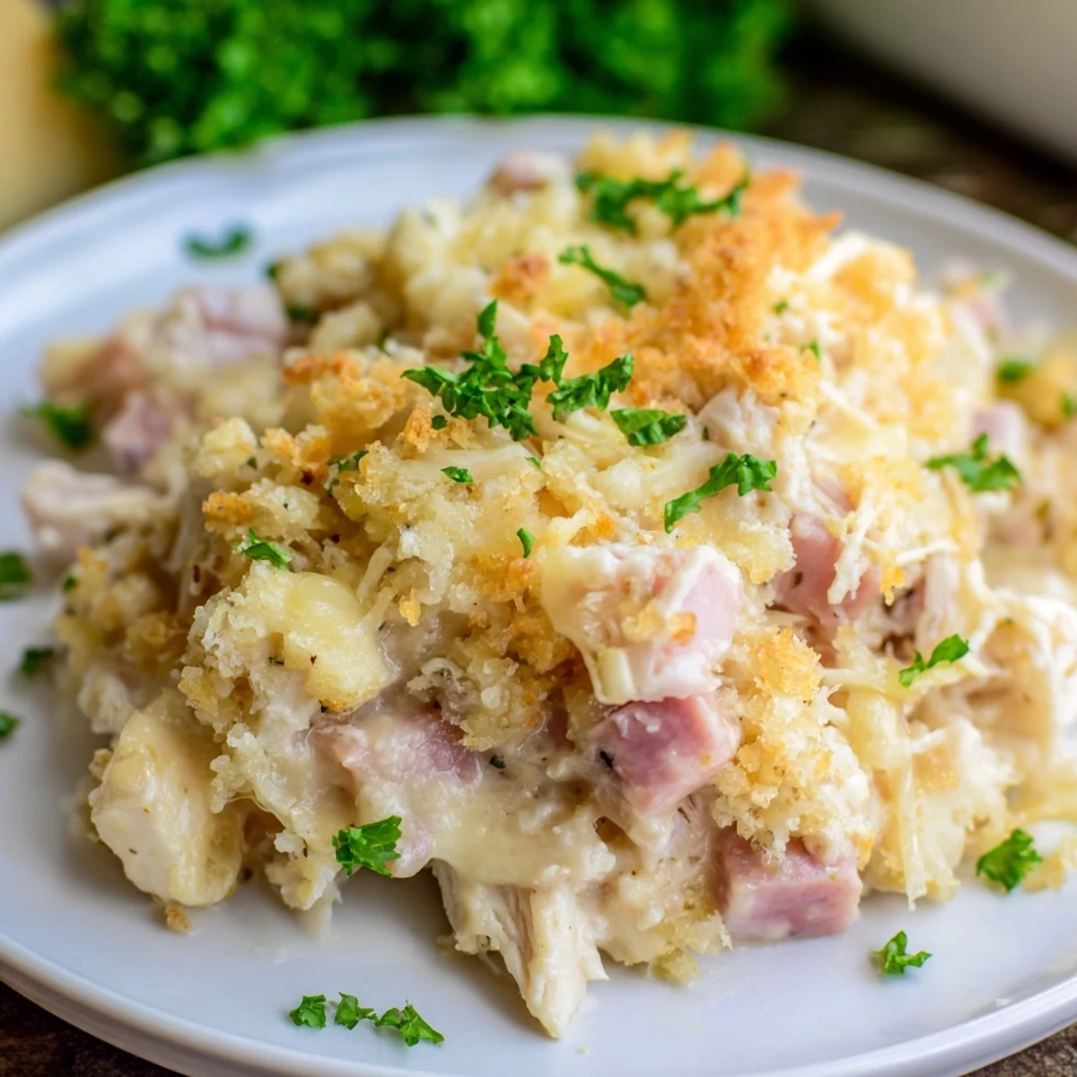Rich and creamy Chicken Cordon Bleu Casserole served on a plate, featuring Swiss cheese and diced ham.