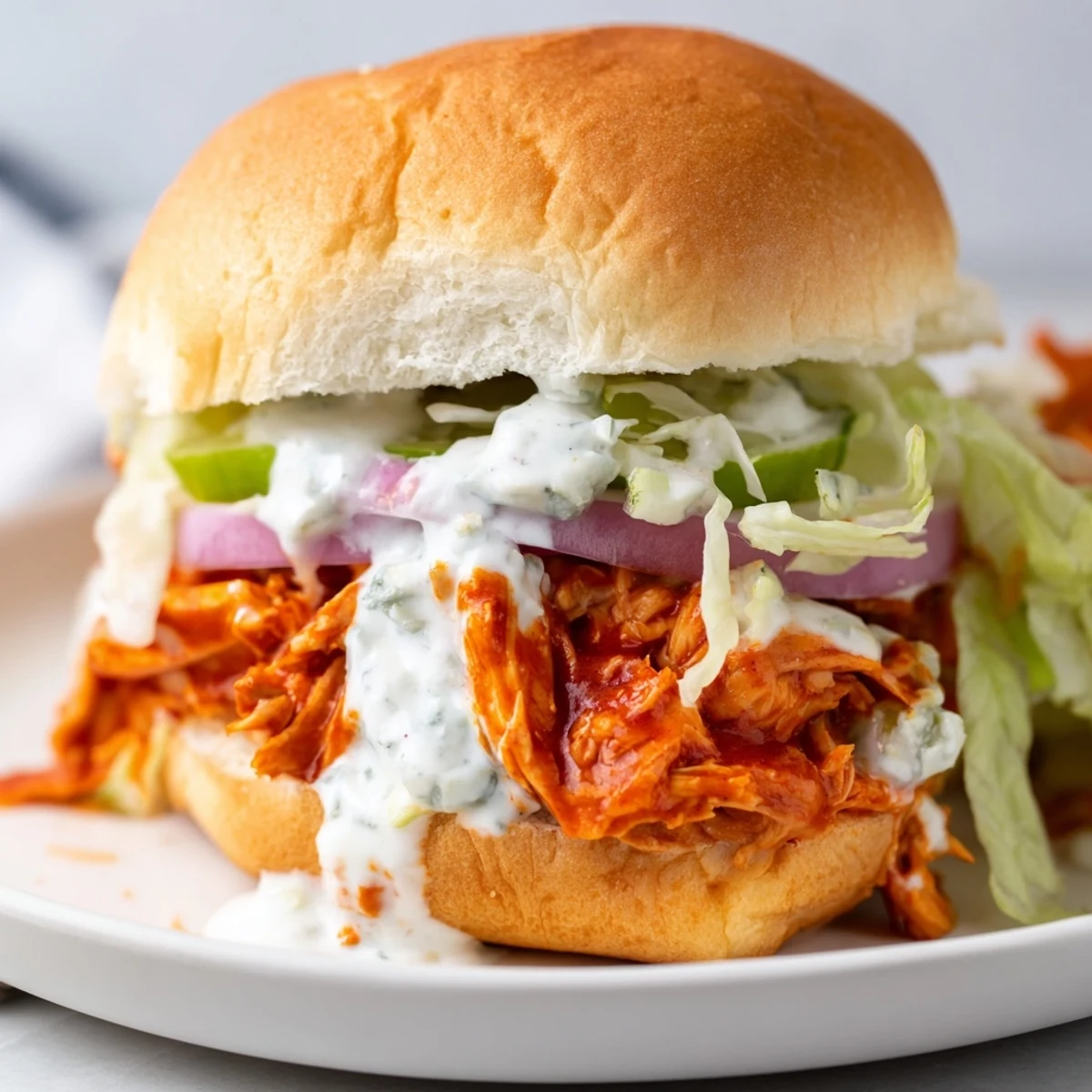 Freshly assembled Spicy Buffalo Chicken Sliders with Blue Cheese, featuring tender shredded chicken tossed in zesty Buffalo sauce.  