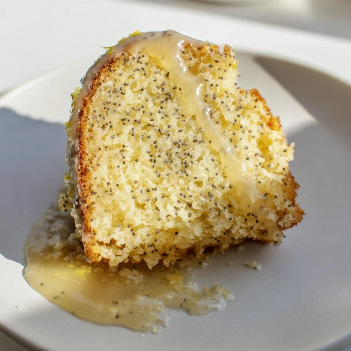 Overhead view of Lemon Poppy Seed Bundt Cake with Glaze, showing golden Bundt shape and crunchy poppy seeds.