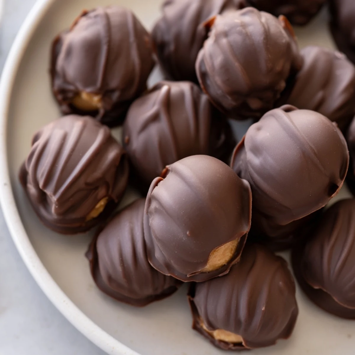 Close-up of a bite-sized Chocolate Peanut Butter Egg showing rich chocolate shell and peanut butter center.