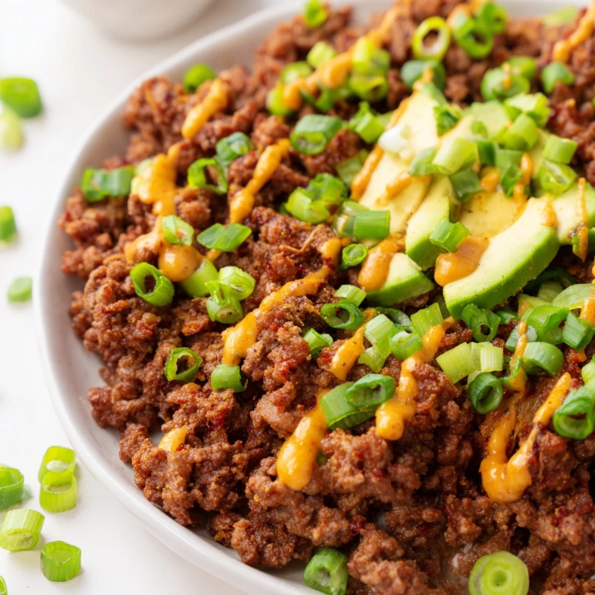 A close-up view of the viral hot honey ground beef bowl with roasted vegetables and black beans.