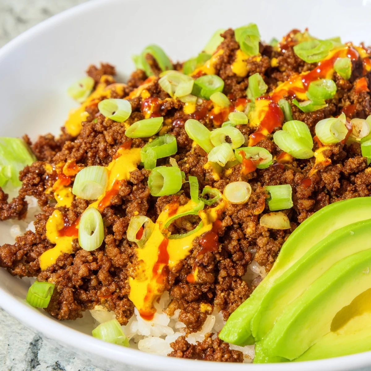 Healthy viral hot honey ground beef bowl with brown rice, avocado, and green onions.