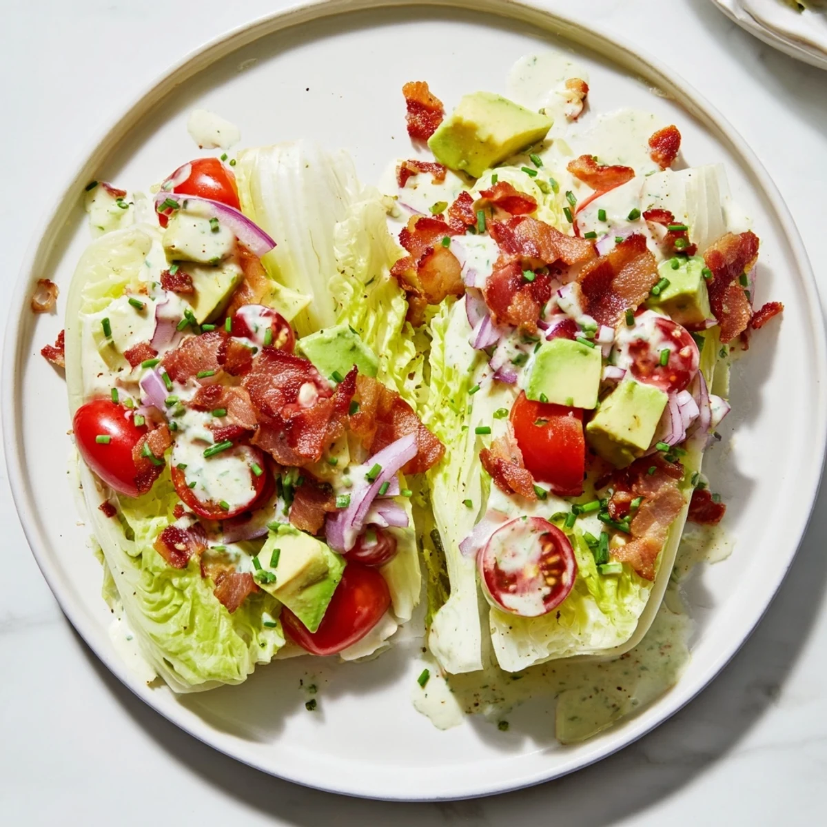 Crispy Bacon Keto BLT Salad with fresh avocado slices and creamy dressing on a rustic table.