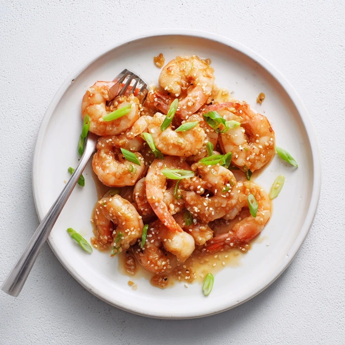 Juicy High Protein Honey Garlic Shrimp glistening in a sweet-savory glaze served over fluffy white rice.