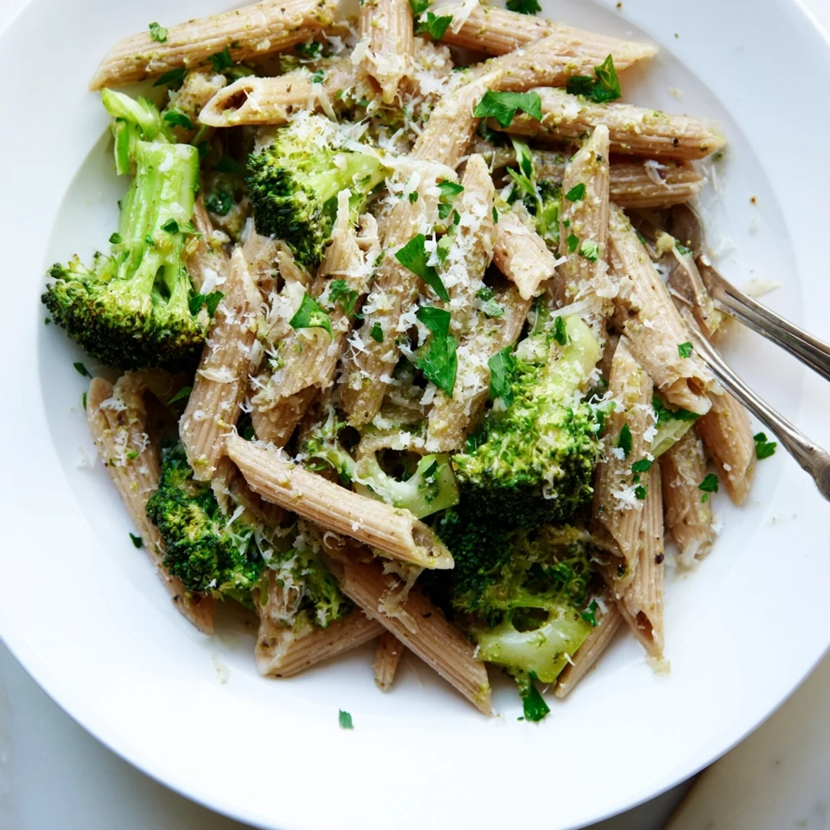Warm serving bowls of Easy Healthy Broccoli Pasta show tender broccoli, garlicky noodles, and a light lemon-infused sauce, perfect for a quick vegetarian weeknight dinner.