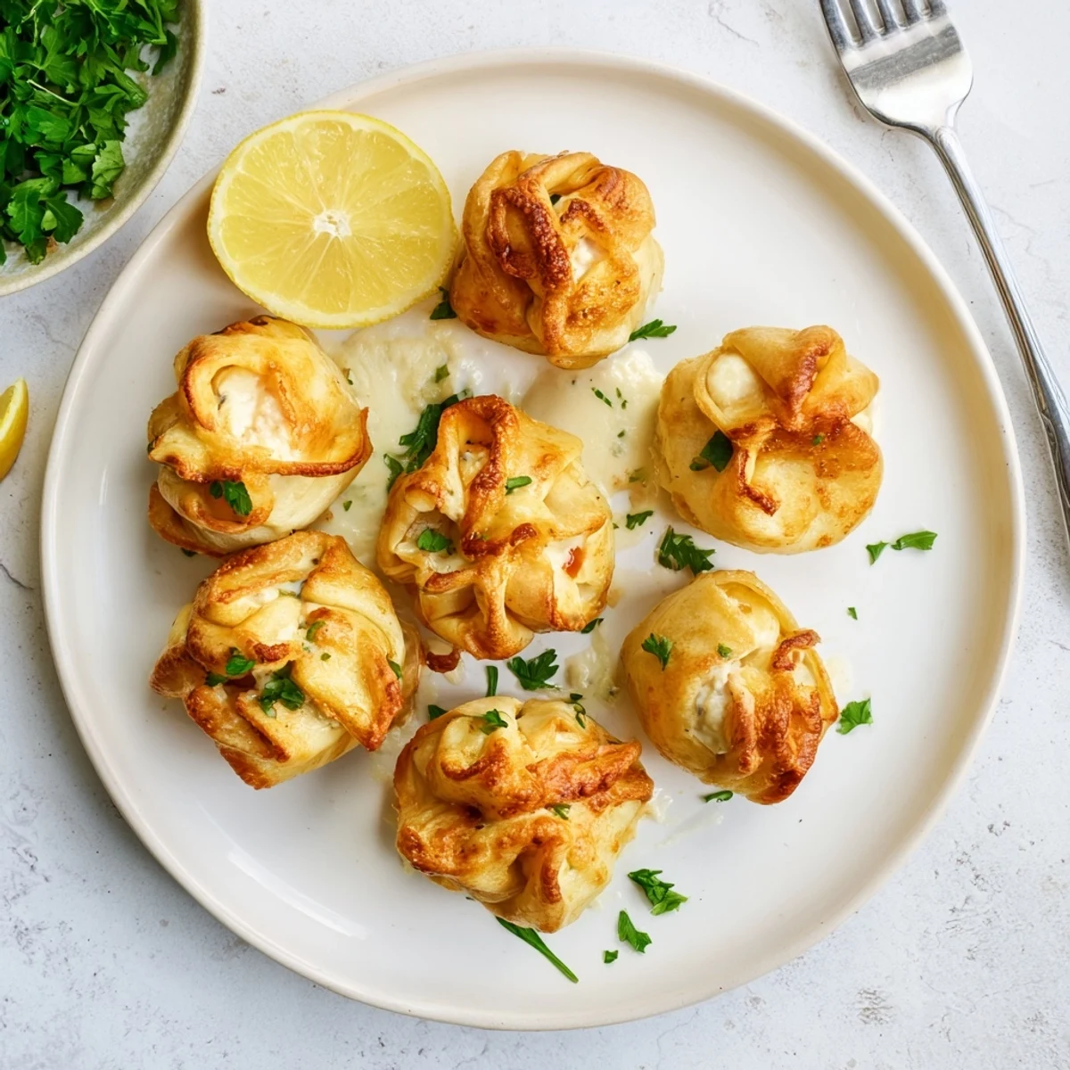 Cheesy Seafood Tortilla Bombs fried until golden, served warm with lemon wedges.