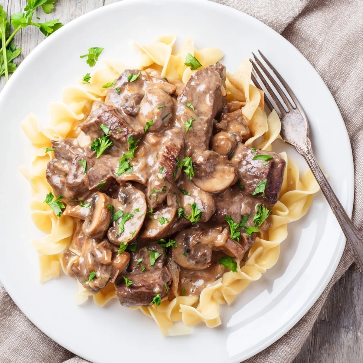 Tender beef strips and earthy mushrooms in rich sour cream sauce over pasta