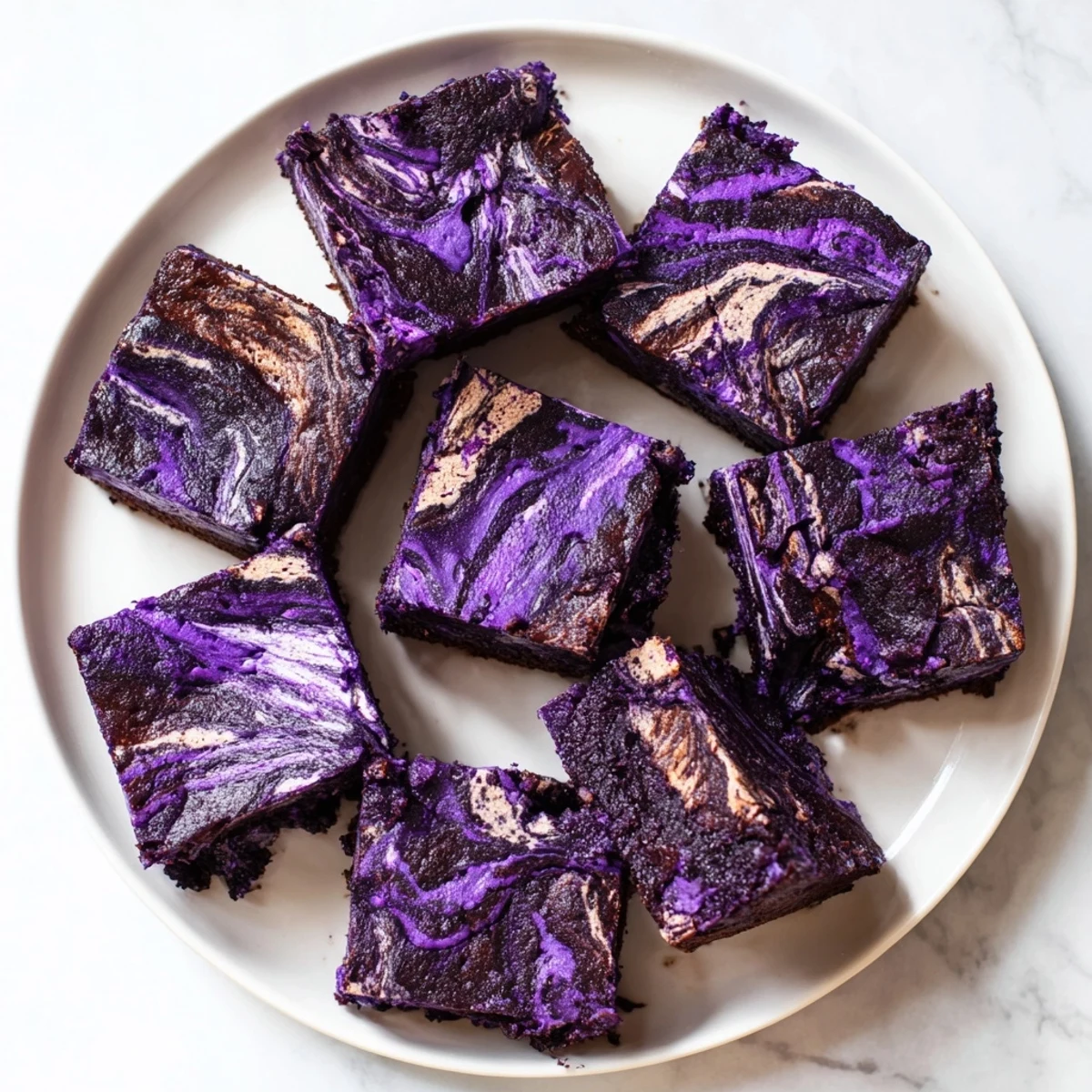 Rich ube brownie bars displaying purple yam color with glossy chocolate ribbon design