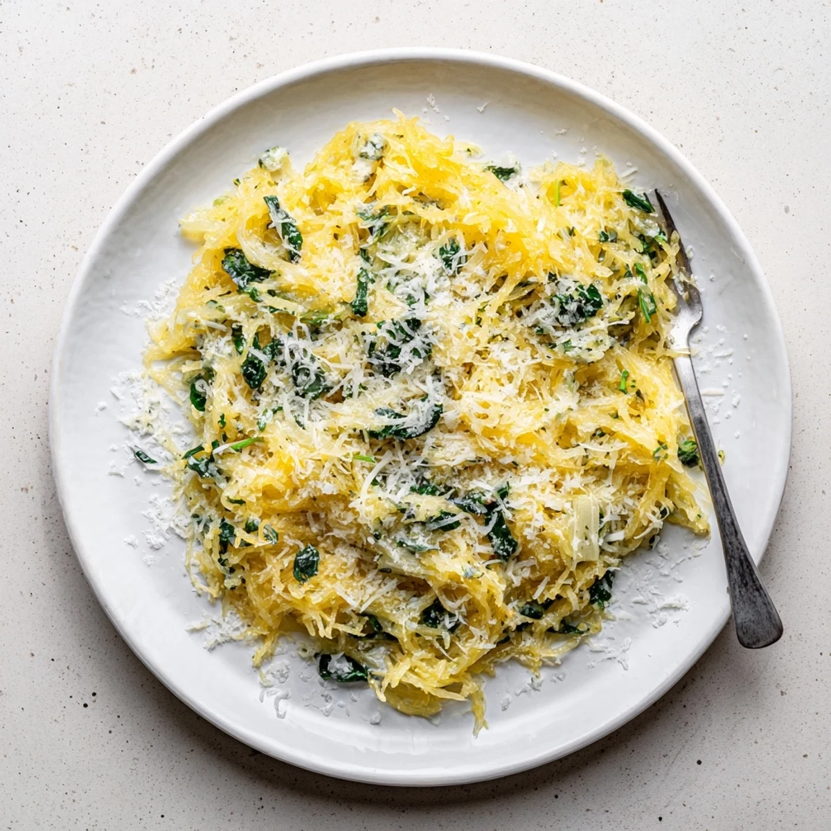 Roasted spaghetti squash tossed with garlic Boursin cheese and tender spinach leaves for a comforting vegetarian dinner