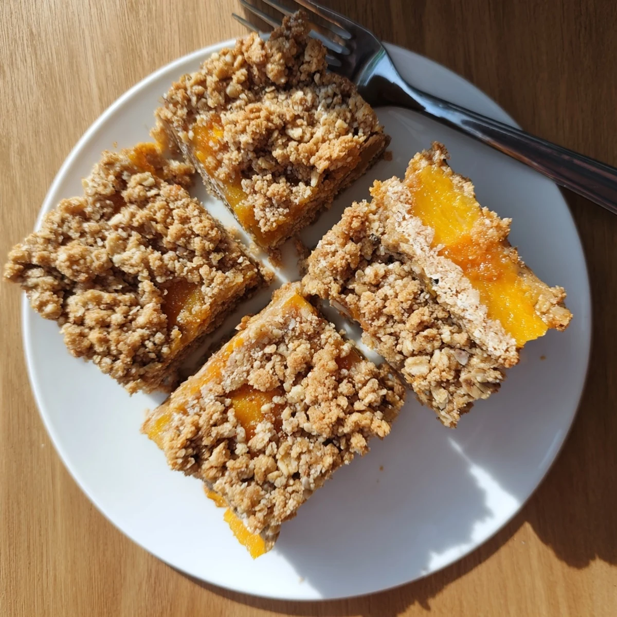 Homemade gluten-free oatmeal apricot bars featuring sweet apricot filling and speckled oat crumble