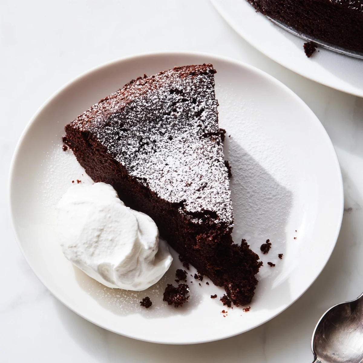 Decadent slice of easy Guinness chocolate cake served with vanilla ice cream scoop