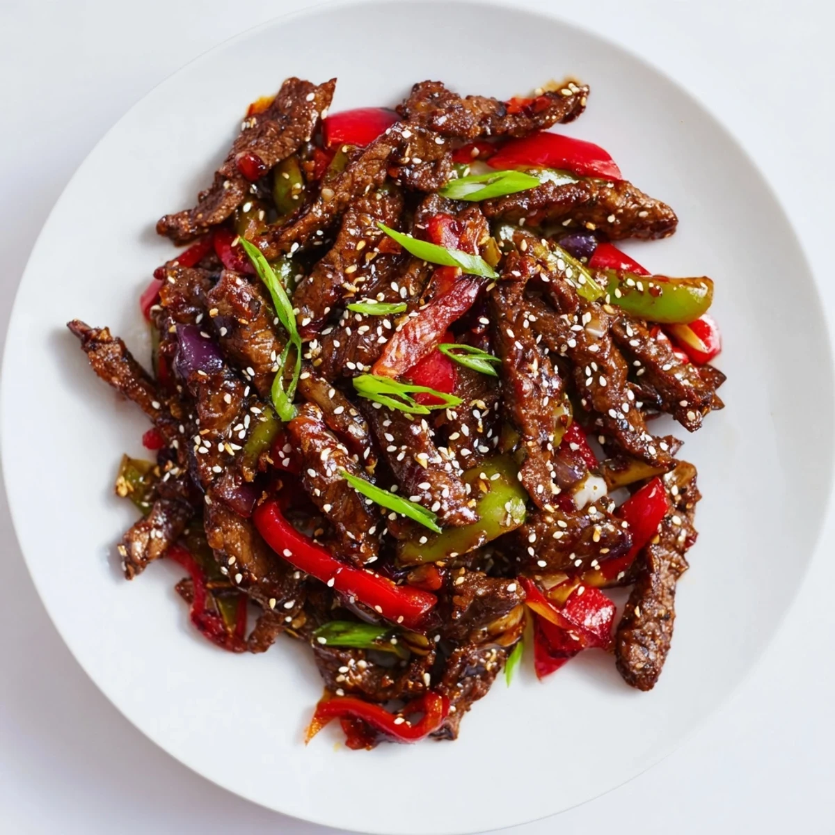 Golden crispy chilli beef with colorful bell peppers in spicy glossy sauce
