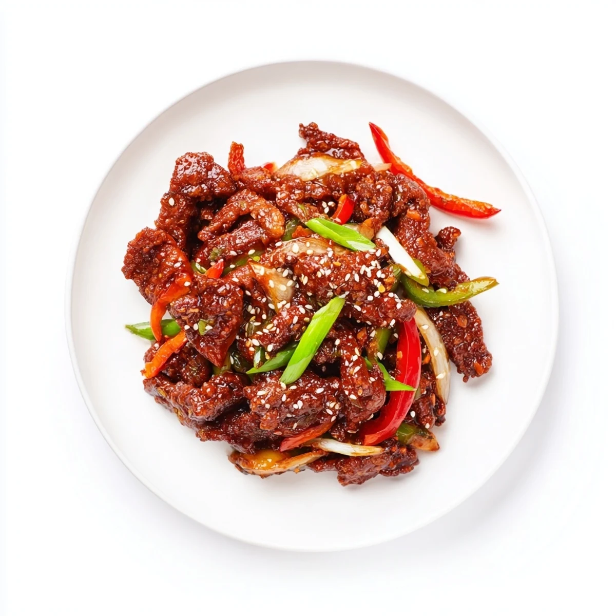 Homemade crispy chilli beef stir fry topped with sesame seeds and fresh coriander