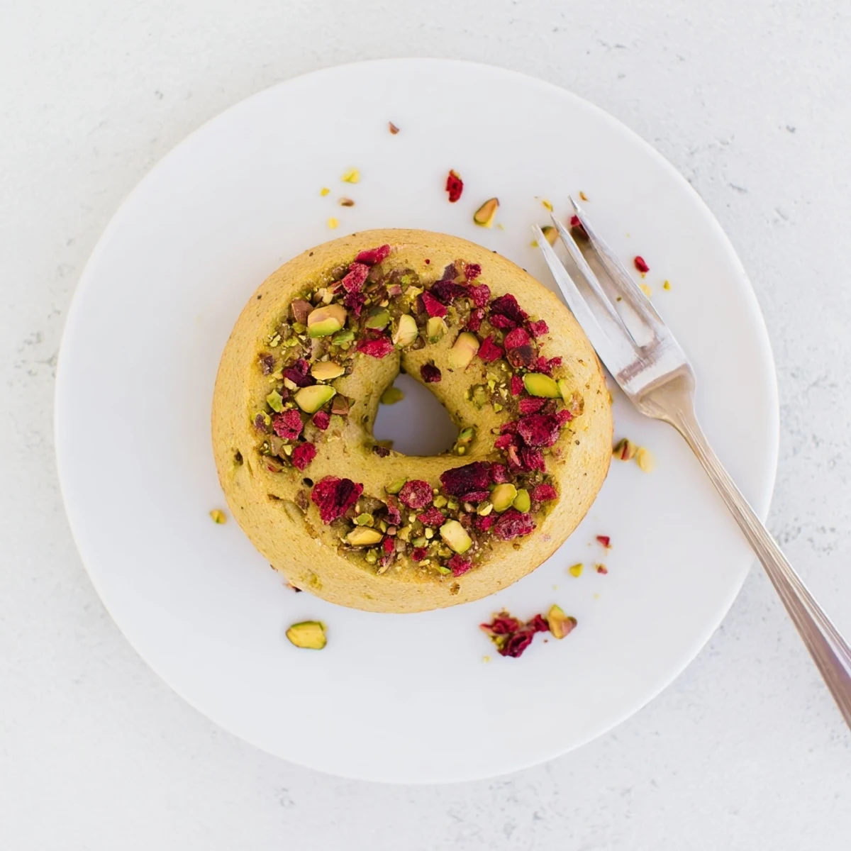 Chewy homemade Raspberry Pistachio Sourdough Bagels fresh from the oven with speckled fruit throughout