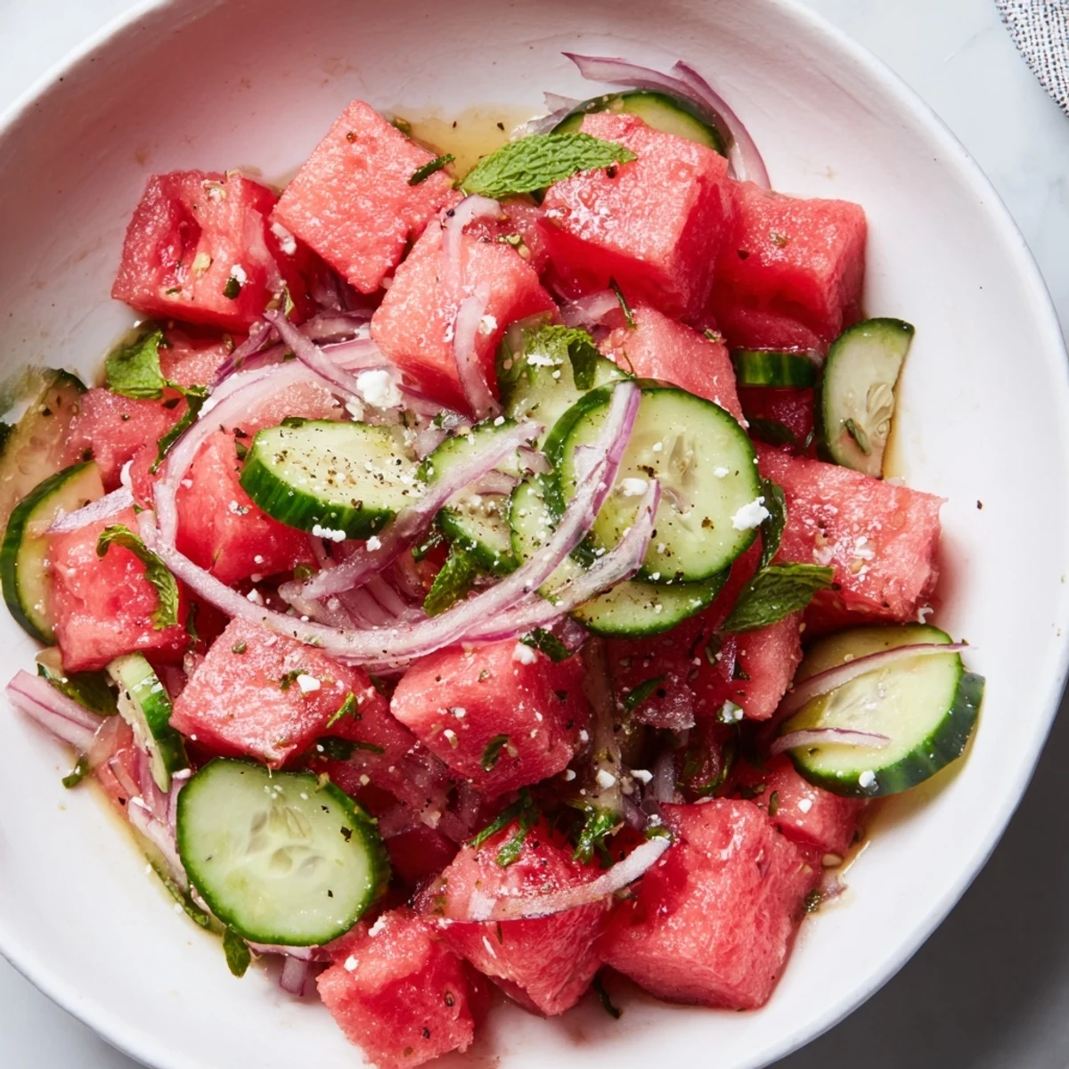 Chilled Watermelon Cucumber Salad tossed in zesty lime dressing, picnic ready