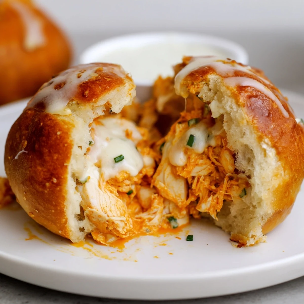 Close-up of split Buffalo Chicken Mozzarella Bombs oozing spicy cheese, ready to share
