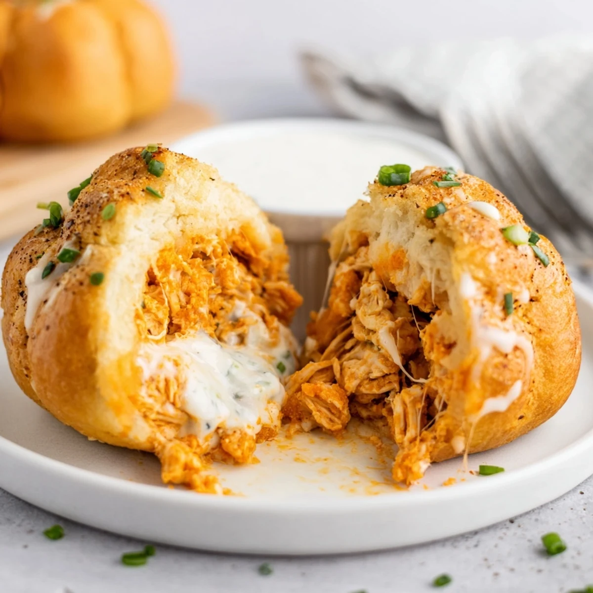 Golden Buffalo Chicken Mozzarella Bombs steaming on parchment, brushed with garlic butter