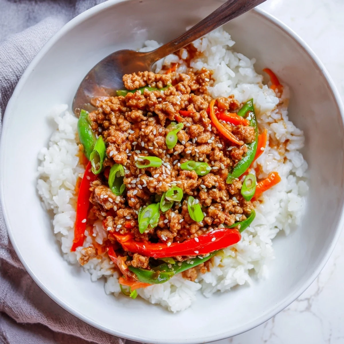 Teriyaki Turkey Rice Bowls steaming with glossy sauce over fluffy jasmine rice, sesame seeds