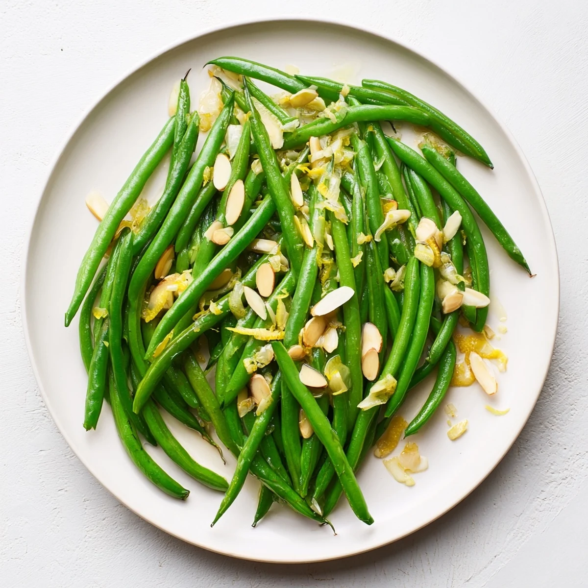 Vibrant sautéed green beans glistening with olive oil and sliced garlic cloves