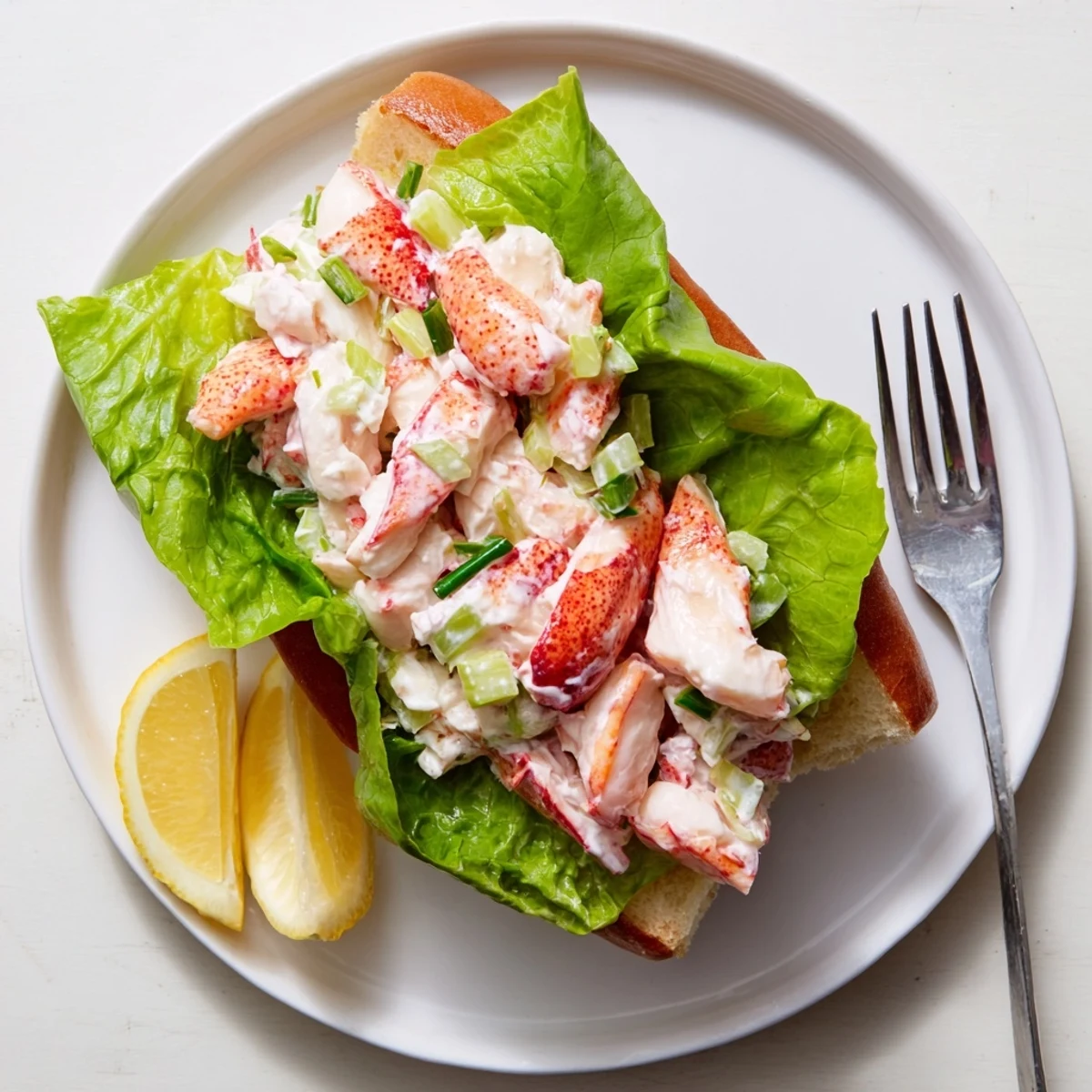 Classic Maine style lobster rolls featuring creamy dressed lobster meat nestled in warm butter grilled New England rolls