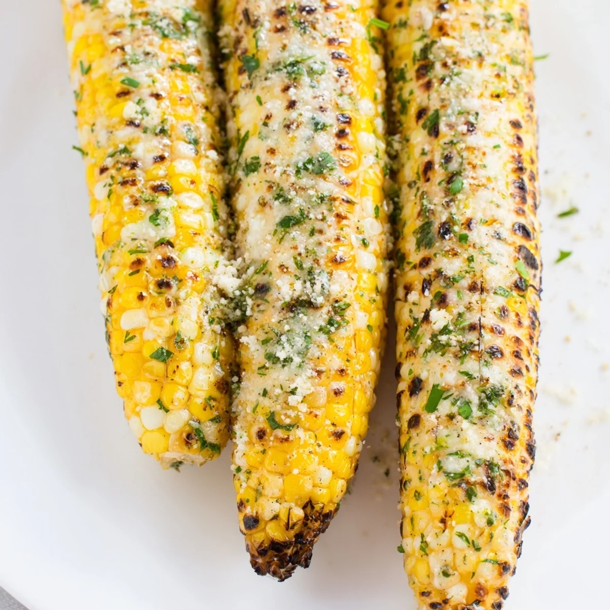 Flame-charred sweet corn ears brushed with herb butter and dusted with zesty parmesan ranch seasoning for summer barbecues
