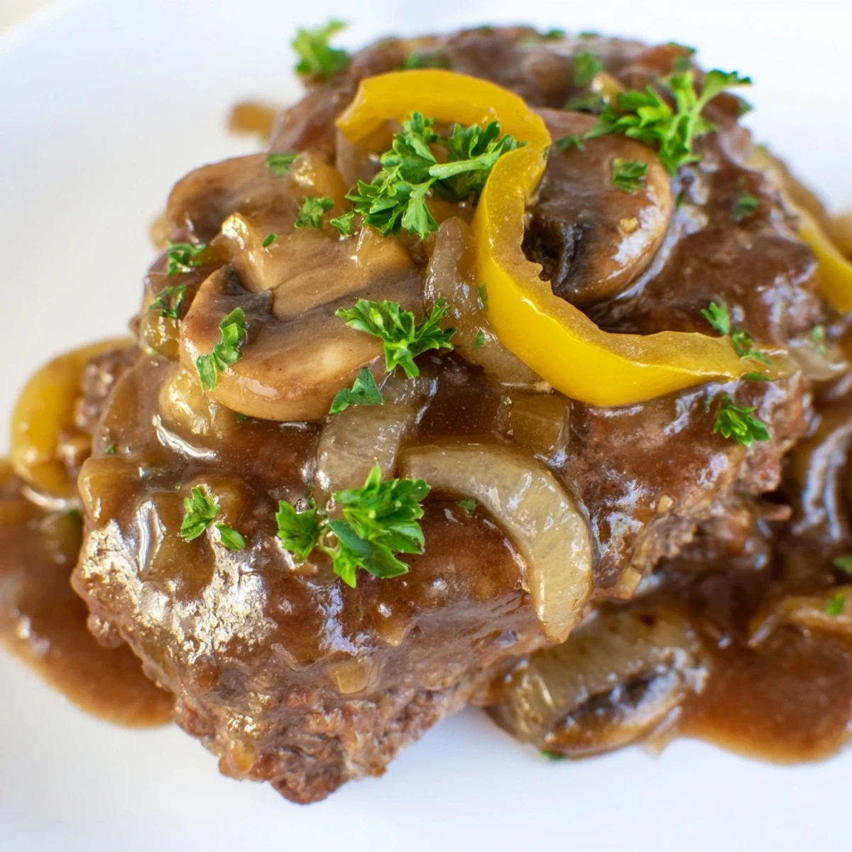 Golden brown cube steaks nestled in a rich onion mushroom gravy sauce.