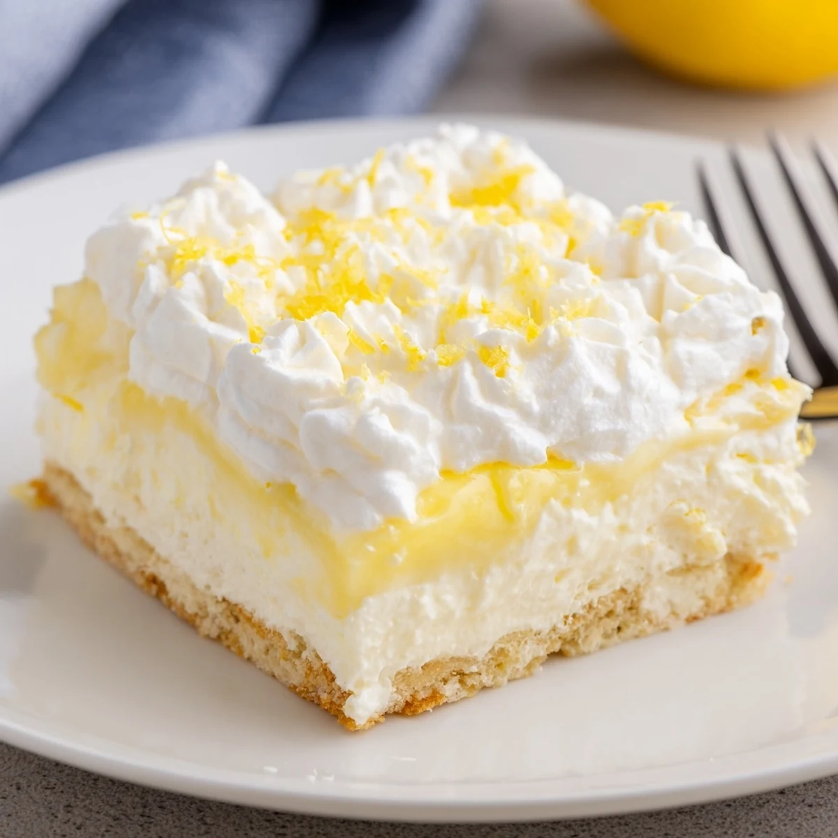 Chilled Lemon Lush Cake layered over buttery crust, creamy lemon filling