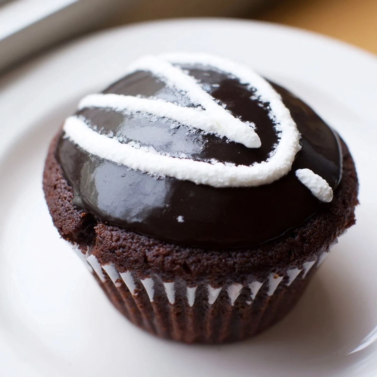 Homemade Hostess Cupcakes with glossy chocolate ganache and fluffy marshmallow filling
