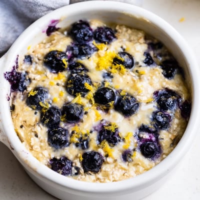 Creamy baked cottage cheese and juicy blueberries make a protein-rich Baked Blueberry Cottage Cheese Breakfast Bowls recipe.