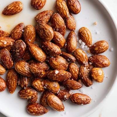 Warm roasted almonds in a rustic bowl seasoned with smoked paprika and salt
